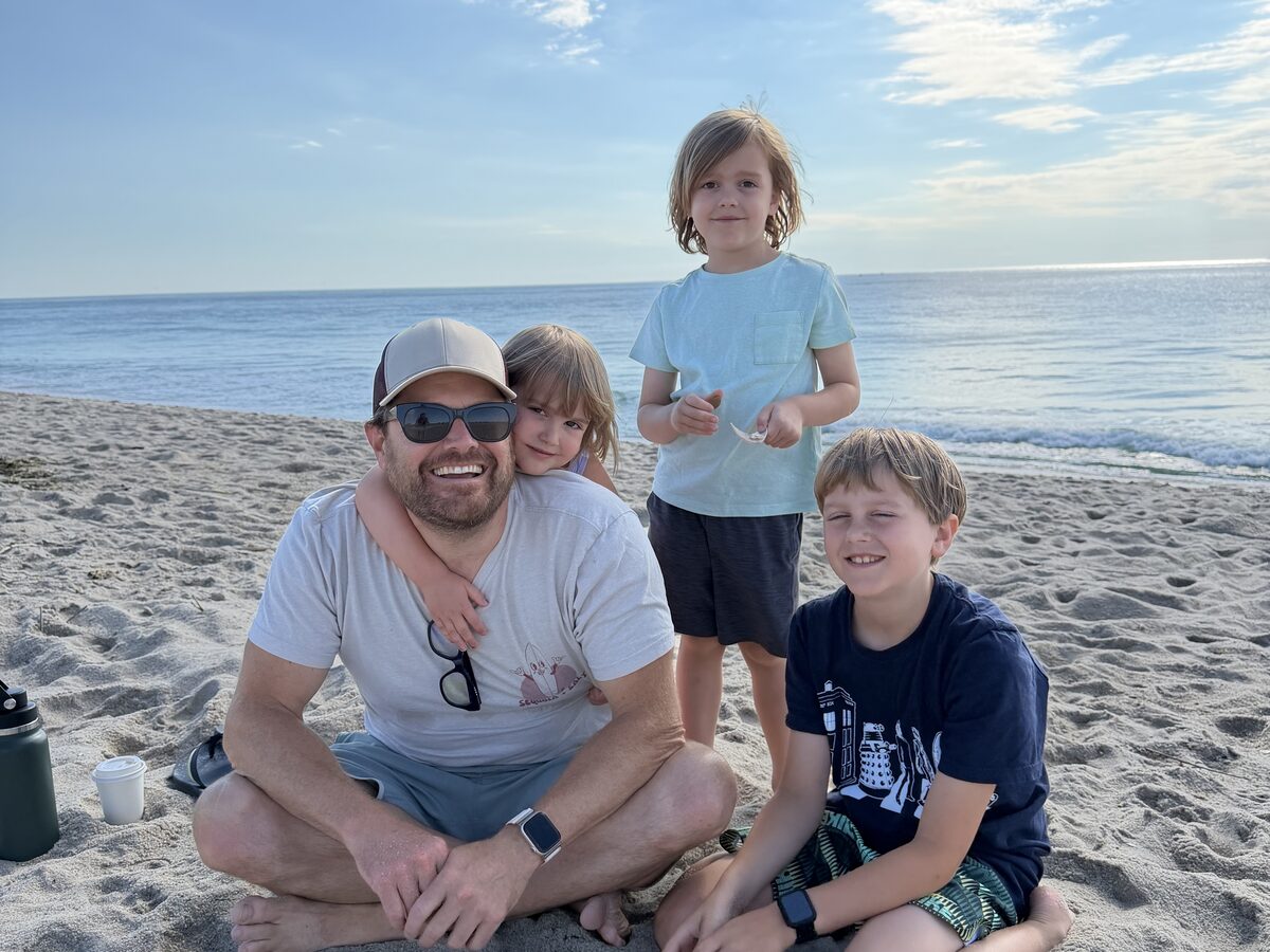 Bret Morgan with his three kids on the beach